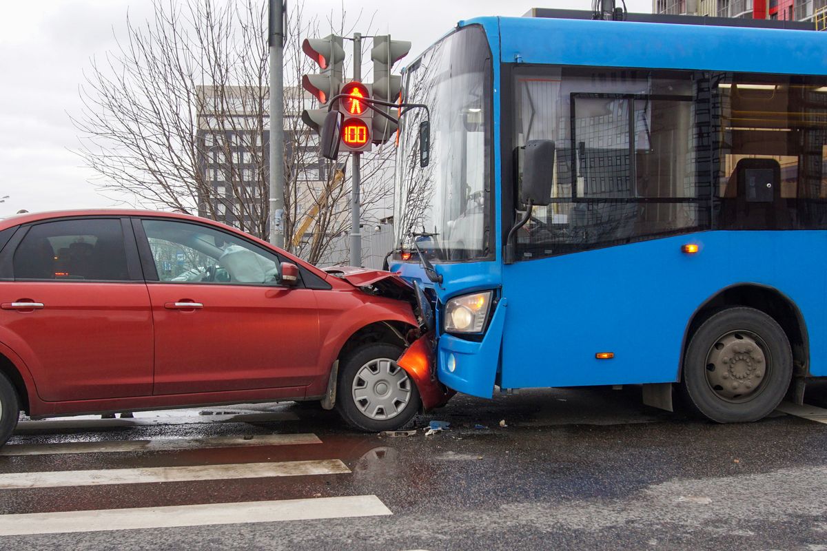 Frontal collision of a car and a bus. Head-on collision between bus and car. Car accident. Traffic accident.